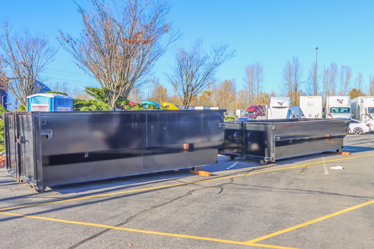 Professional dumpster rental service with roll-off container on residential driveway in Clear Lake